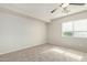 Spacious bedroom with ceiling fan and neutral carpeting at 6537 W Riva Rd, Phoenix, AZ 85043
