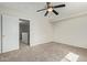 Bright bedroom with ceiling fan, carpet, and access to additional rooms at 6537 W Riva Rd, Phoenix, AZ 85043