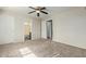 Primary bedroom with ceiling fan, carpet flooring, and bathroom access at 6537 W Riva Rd, Phoenix, AZ 85043