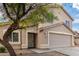 Two-story house with tan exterior, decorative door, and garage at 6537 W Riva Rd, Phoenix, AZ 85043