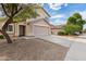 Two-story house with tan exterior, landscaping, and driveway at 6537 W Riva Rd, Phoenix, AZ 85043