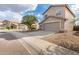 Two-story house with tan exterior, garage, and street view at 6537 W Riva Rd, Phoenix, AZ 85043