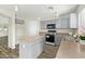 Modern kitchen with gray cabinets, an island, and stainless steel appliances at 6537 W Riva Rd, Phoenix, AZ 85043