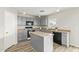 Modern kitchen with gray cabinets, an island, and stainless steel appliances at 6537 W Riva Rd, Phoenix, AZ 85043