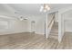 Bright living room with laminate flooring, ceiling fan, and access to kitchen and stairs at 6537 W Riva Rd, Phoenix, AZ 85043