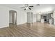 Open living room features laminate wood floor, kitchen view, and access to other rooms at 6537 W Riva Rd, Phoenix, AZ 85043