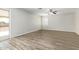 Living room with wood-look floors, sliding door to backyard at 6537 W Riva Rd, Phoenix, AZ 85043