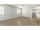Open living room with wood-look floors and view to kitchen at 6537 W Riva Rd, Phoenix, AZ 85043
