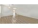 Spacious living room with wood-look floors and access to other rooms at 6537 W Riva Rd, Phoenix, AZ 85043