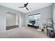 Bright living room featuring carpet, large TV, and access to the entryway at 6709 W Pleasant Oak Ct, Florence, AZ 85132