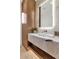 Modern bathroom featuring a marble vanity, illuminated mirror, and sleek wood accents at 6836 E Hummingbird Ln, Paradise Valley, AZ 85253