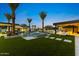 Resort-style pool with lush landscaping and outdoor kitchen, perfect for entertaining and relaxation at 6836 E Hummingbird Ln, Paradise Valley, AZ 85253