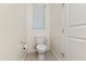 Clean half bathroom with a white toilet, neutral walls, and tiled floor at 7042 E Diamond St, Scottsdale, AZ 85257