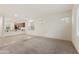 Bright, open-concept living room flowing into the kitchen with tile and carpet flooring at 7042 E Diamond St, Scottsdale, AZ 85257