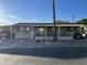 Single-wide manufactured home with covered porch and carport at 9333 E University Dr # 147, Mesa, AZ 85207