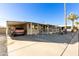 Mobile home with carport and landscaped front yard at 9333 E University Dr # 147, Mesa, AZ 85207