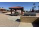 Community gazebo with picnic tables, barbecue, and desert landscaping on a sunny day at 9333 E University Dr # 147, Mesa, AZ 85207