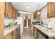 Long kitchen with wood cabinets, appliances, and ample counter space at 9333 E University Dr # 147, Mesa, AZ 85207