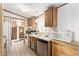 Efficient kitchen featuring wood cabinets, appliances, and vinyl flooring at 9333 E University Dr # 147, Mesa, AZ 85207