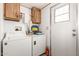 Laundry room with washer, dryer, and storage cabinets at 9333 E University Dr # 147, Mesa, AZ 85207