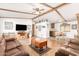 Spacious living room with leather sofas, wood flooring, and a view into the kitchen at 9333 E University Dr # 147, Mesa, AZ 85207