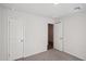 Well-lit bedroom with plush carpeting and two closets at 9930 W Carousel Dr, Arizona City, AZ 85123