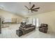 Living room with tile floors, a sofa, and a ceiling fan at 11503 W Cyprus Dr, Avondale, AZ 85392