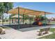 playground with shade structure, swings, and play equipment at 11503 W Cyprus Dr, Avondale, AZ 85392