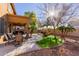 Landscaped backyard featuring a patio and fire pit area at 117 E Blue Lagoon Dr, Casa Grande, AZ 85122