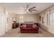 Main bedroom with a red couch and ceiling fan at 117 E Blue Lagoon Dr, Casa Grande, AZ 85122