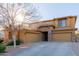 Two-story house with stone accents and three-car garage at 117 E Blue Lagoon Dr, Casa Grande, AZ 85122