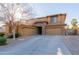 Two-story house with three-car garage and a manicured lawn at 117 E Blue Lagoon Dr, Casa Grande, AZ 85122