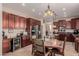 Kitchen features dark wood cabinets, stainless steel appliances, and a breakfast nook at 117 E Blue Lagoon Dr, Casa Grande, AZ 85122