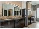 Double vanity bathroom with glass block window and dark cabinets at 11850 E Del Timbre Dr, Scottsdale, AZ 85259