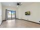 Bedroom featuring a TV, ceiling fan and sliding door to patio at 11850 E Del Timbre Dr, Scottsdale, AZ 85259