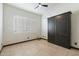 Bright bedroom with tile floors, large window with shutters, and a built-in wall bed at 11850 E Del Timbre Dr, Scottsdale, AZ 85259