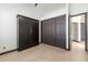 Spacious bedroom with dark wood closet doors and tile floors at 11850 E Del Timbre Dr, Scottsdale, AZ 85259