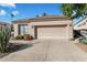 Tan colored house with a two-car garage and desert landscaping at 11850 E Del Timbre Dr, Scottsdale, AZ 85259