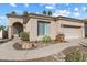 Single-story home with a two-car garage and landscaped front yard at 11850 E Del Timbre Dr, Scottsdale, AZ 85259