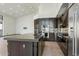 Modern kitchen with dark cabinets, stainless steel appliances and an island at 11850 E Del Timbre Dr, Scottsdale, AZ 85259