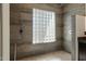 Walk-in shower with glass block window and tiled walls at 11850 E Del Timbre Dr, Scottsdale, AZ 85259