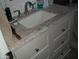 Bathroom vanity featuring marble countertop, cabinet storage, modern faucet, and sink at 12001 N Pebble Beach Dr, Sun City, AZ 85351