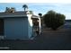 Exterior shot of home with desert landscaping, highlighting back patio and satellite dish at 12001 N Pebble Beach Dr, Sun City, AZ 85351