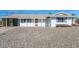 White single story home with carport and gravel driveway at 12001 N Pebble Beach Dr, Sun City, AZ 85351