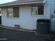 Exterior view of utility hookups and air conditioner, featuring painted brick at 12001 N Pebble Beach Dr, Sun City, AZ 85351