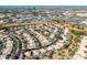 Aerial view of houses and neighborhood with distant city skyline and industrial areas at 1231 N Layman St, Gilbert, AZ 85233