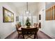 Elegant dining room with a wooden table, chandelier, and artwork at 1231 N Layman St, Gilbert, AZ 85233