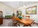 Bright dining room features a large wooden table, chandelier, and window at 1231 N Layman St, Gilbert, AZ 85233