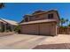 Two-story house with three-car garage and desert landscaping at 1231 N Layman St, Gilbert, AZ 85233