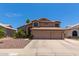 Two-story house with three-car garage and desert landscaping at 1231 N Layman St, Gilbert, AZ 85233